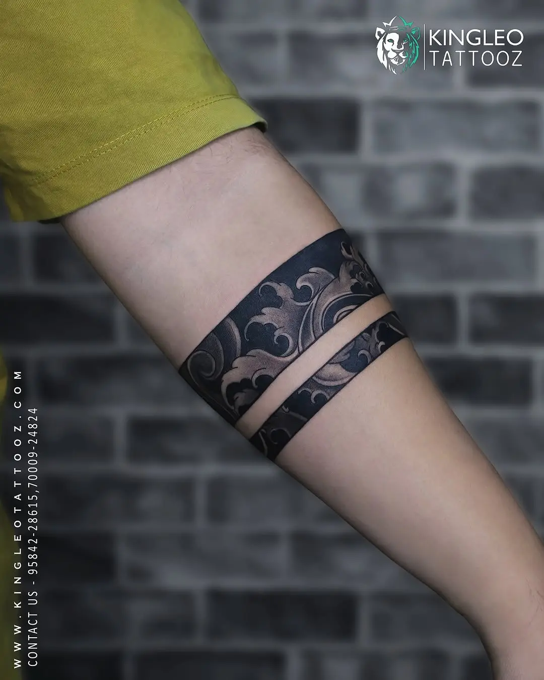 Elegant black armband tattoo with floral patterns