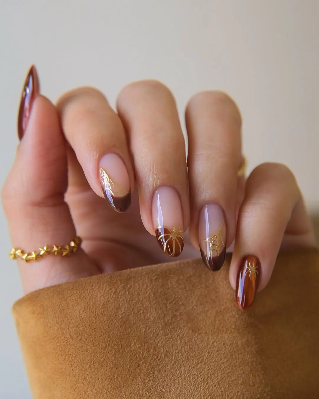 Elegant winter nails with brown and gold accents