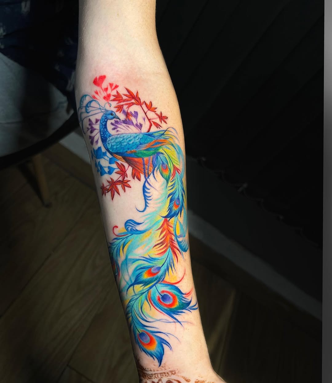 Colorful peacock tattoo with vibrant feathers
