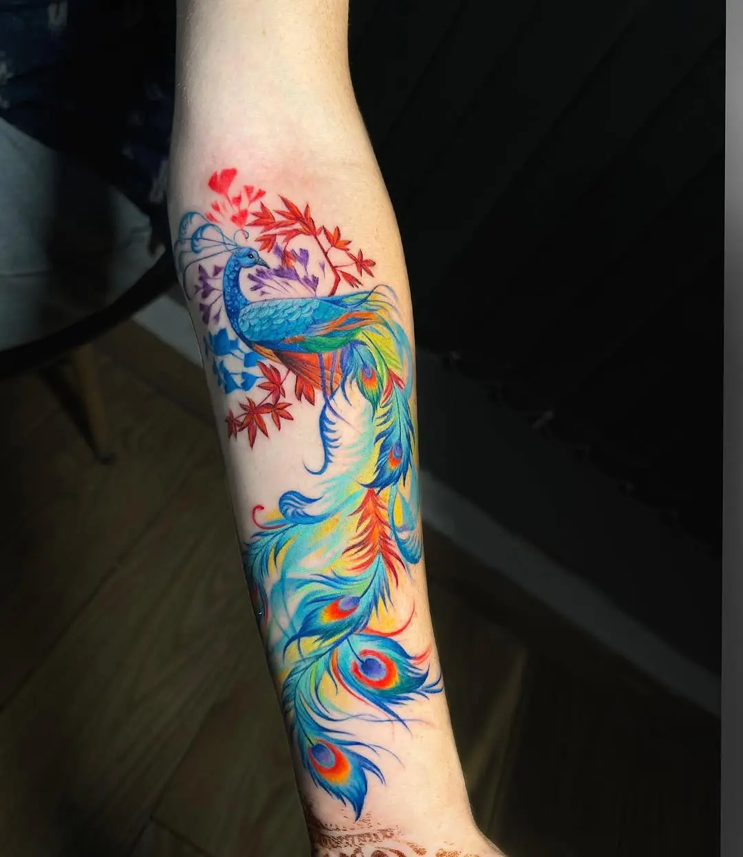 Colorful peacock tattoo with vibrant feathers