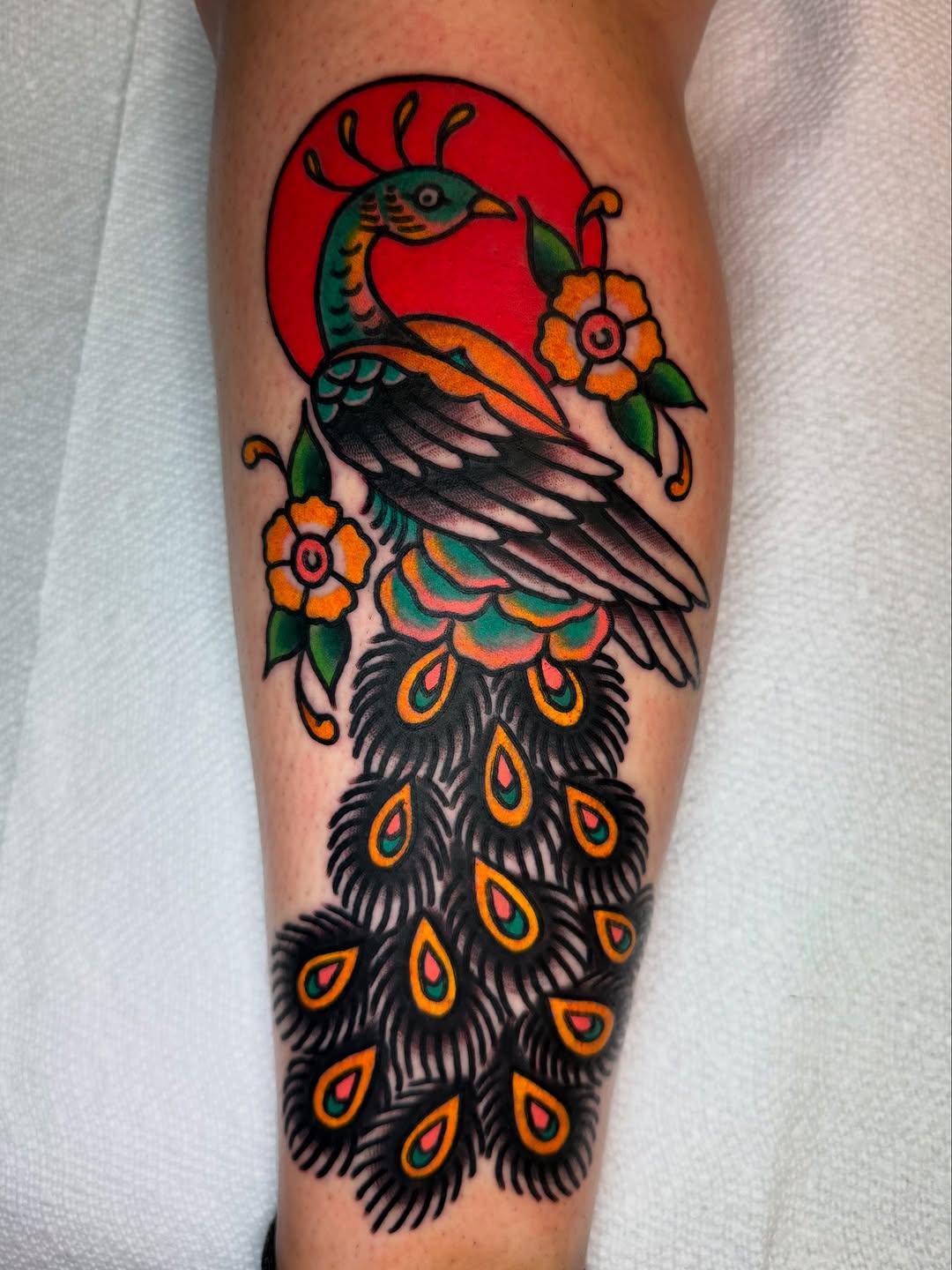 Vibrant Peacock Tattoo with Floral Elements