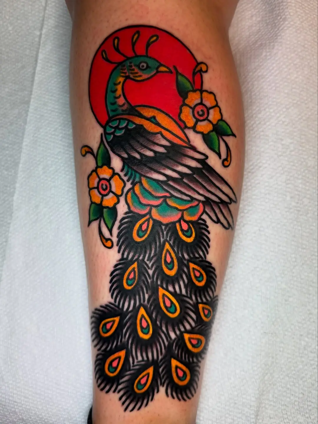 Vibrant Peacock Tattoo with Floral Elements
