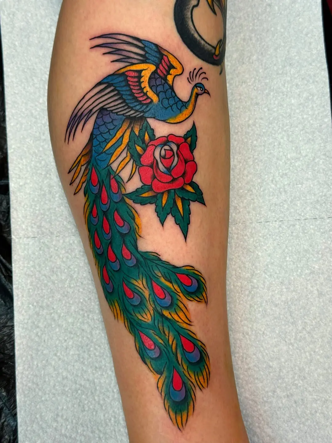 Stunning Peacock Tattoo with Floral Touch