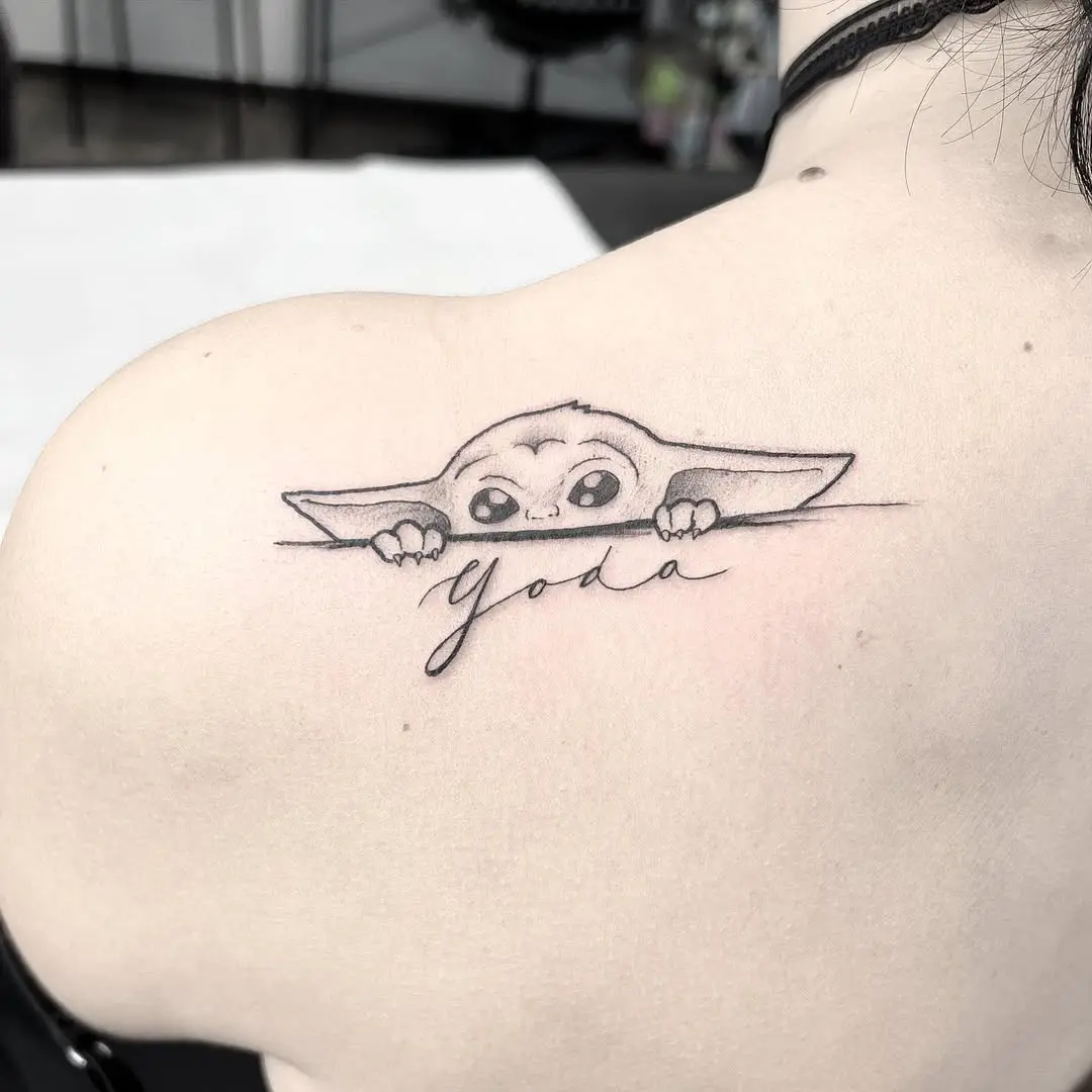Adorable Yoda tattoo with playful vibe
