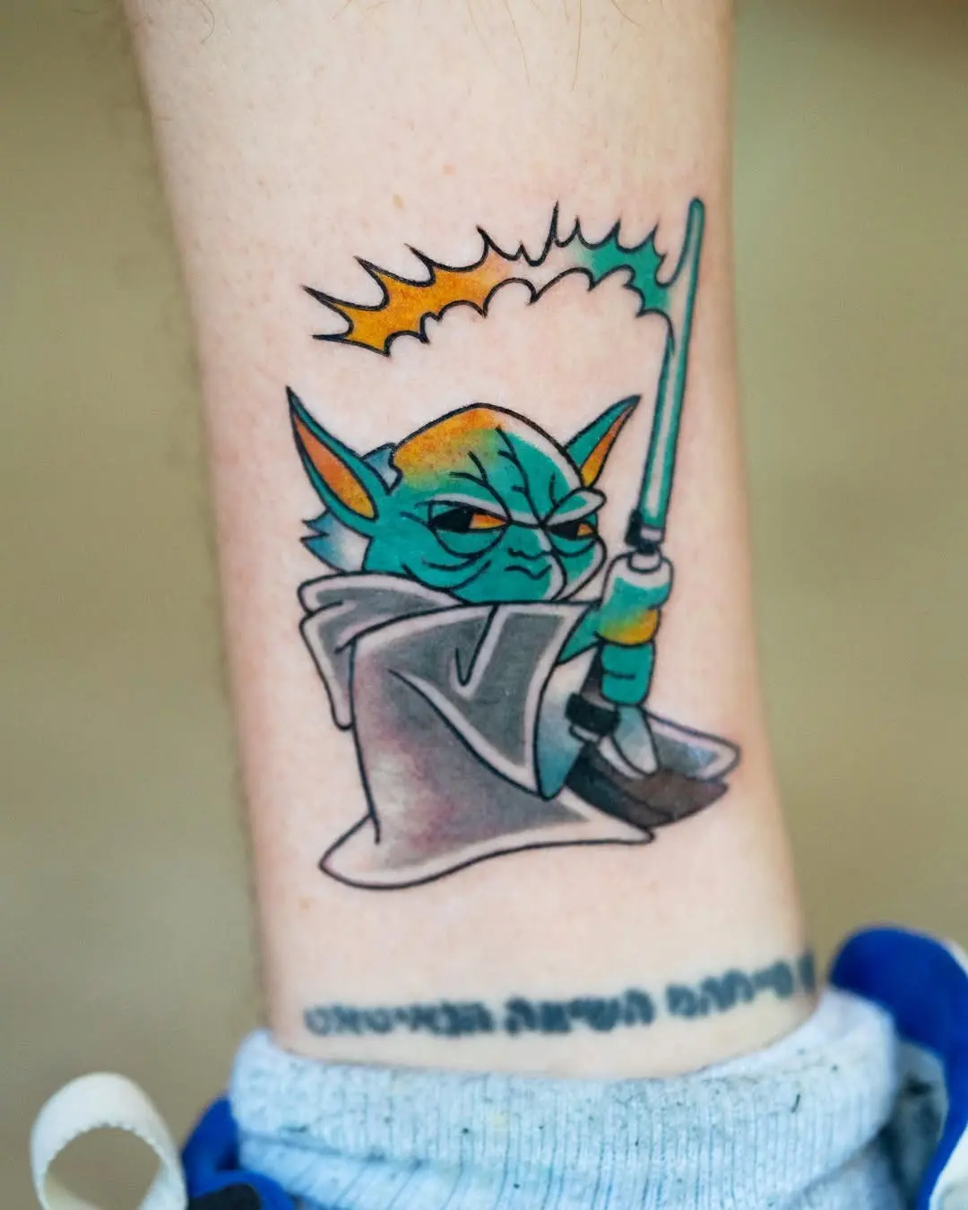 Vibrant Yoda with Lightsaber Tattoo Design