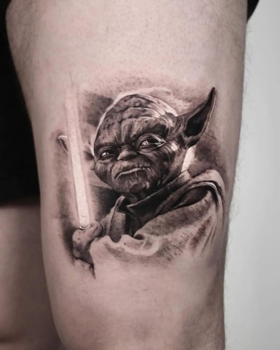 Intricate Yoda Tattoo Holding a Lightsaber