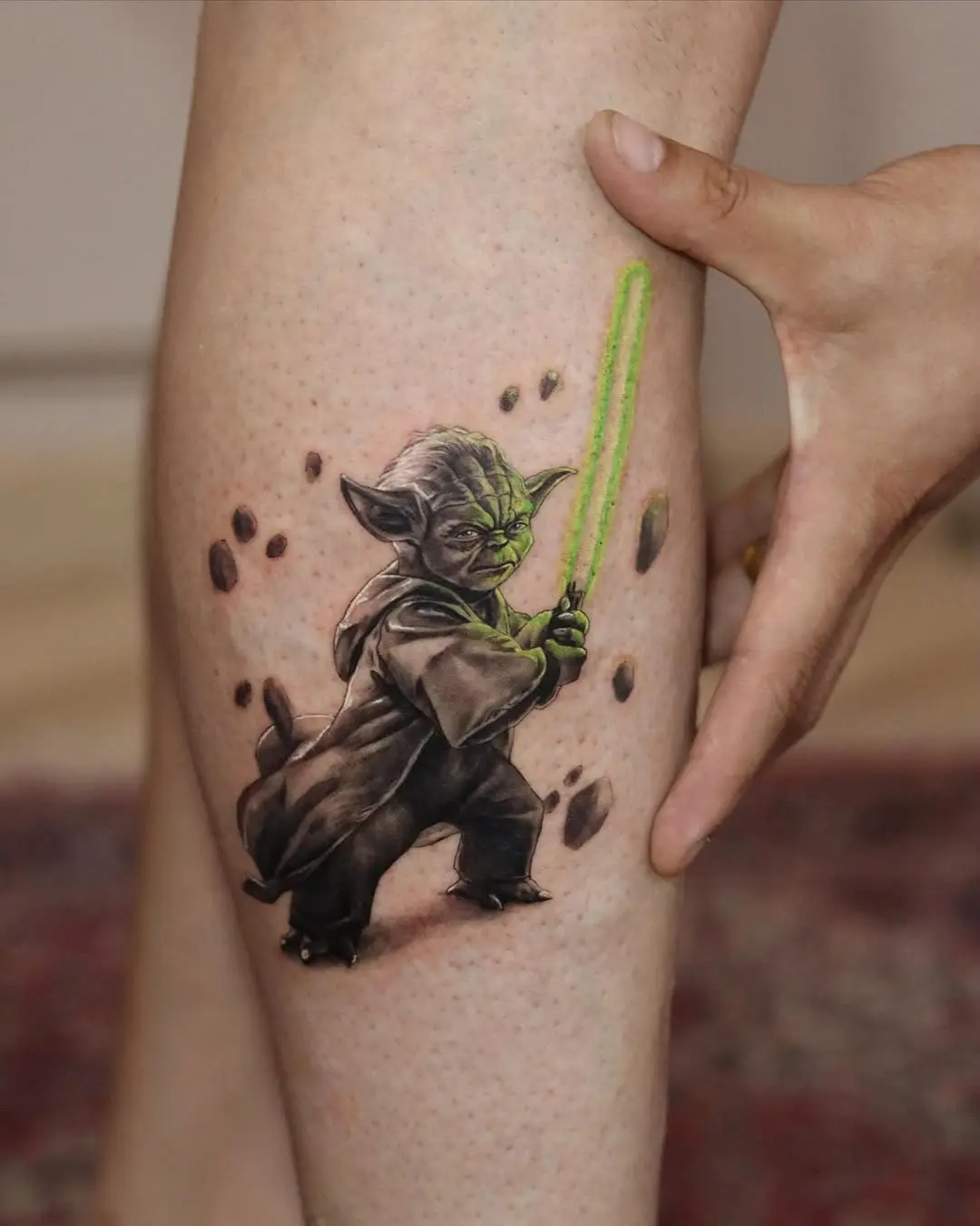 Vibrant Yoda Tattoo with Light Saber