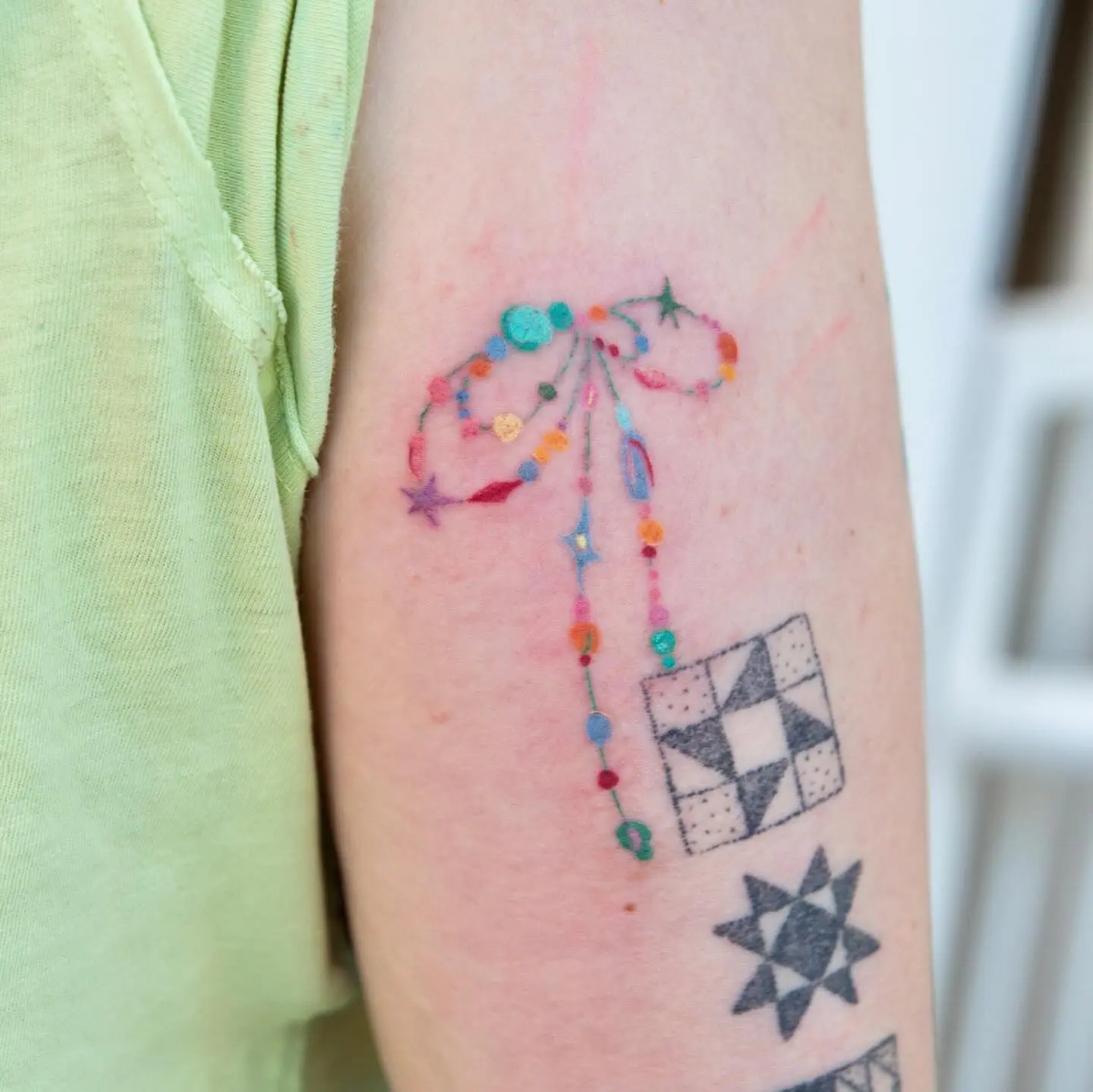 Charming bow tattoo with playful color accents
