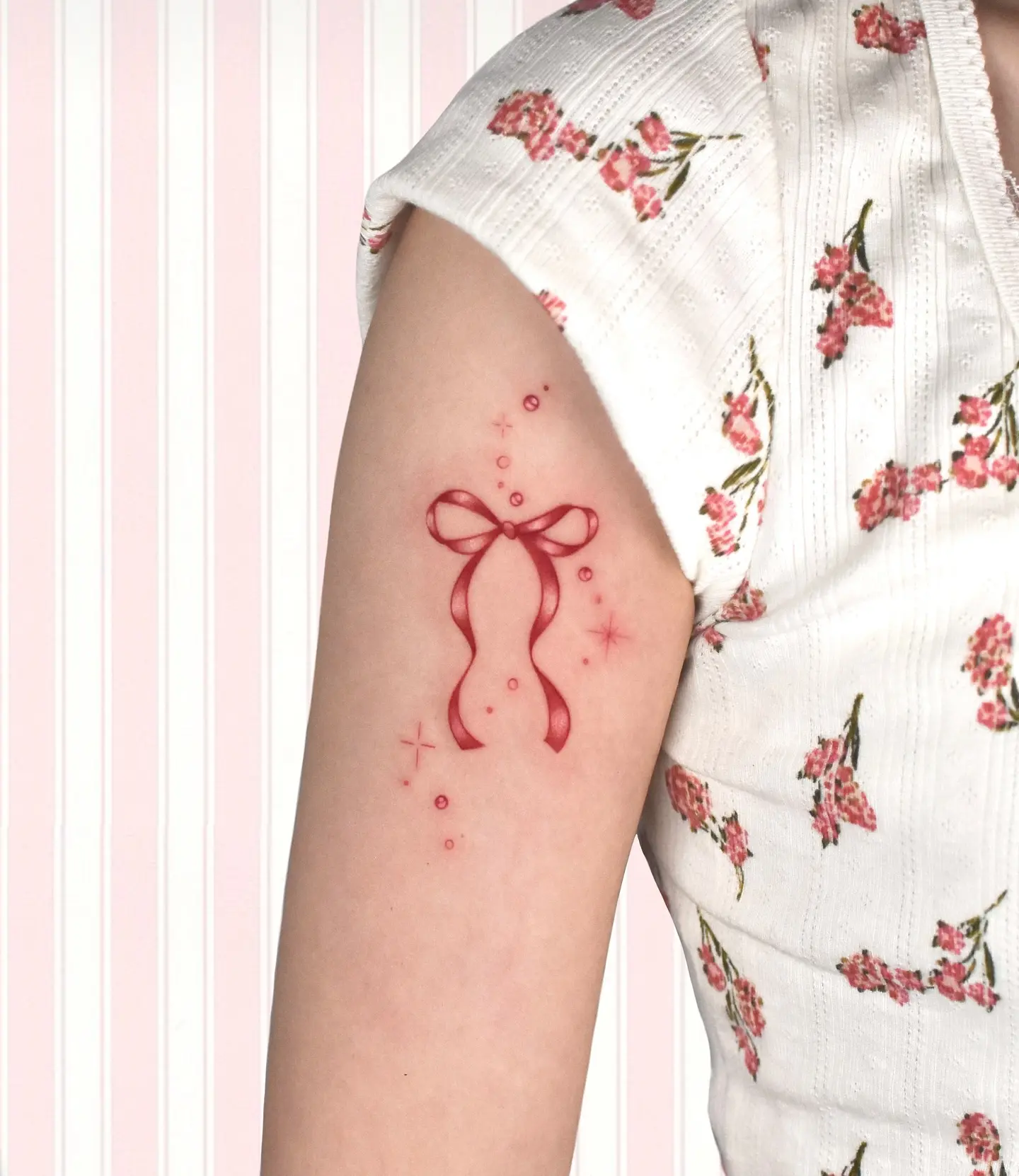 Charming red bow tattoo with floral vibes