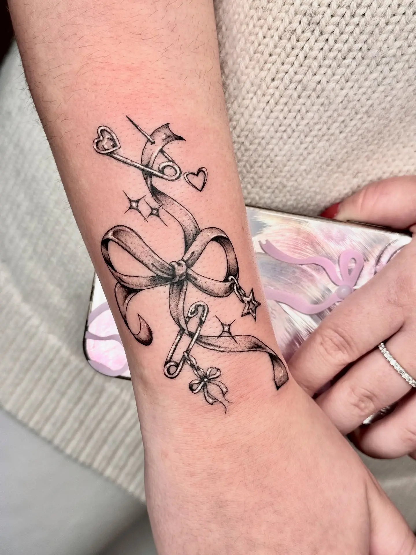 Elegant bow tattoo with charm details