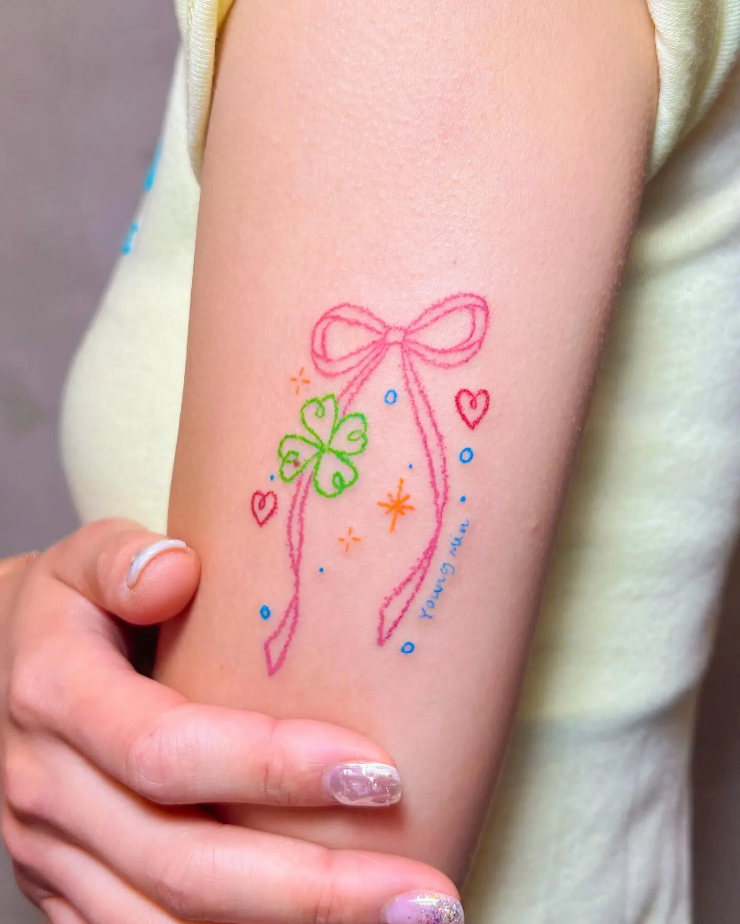 Charming Bow and Clover Tattoo Design