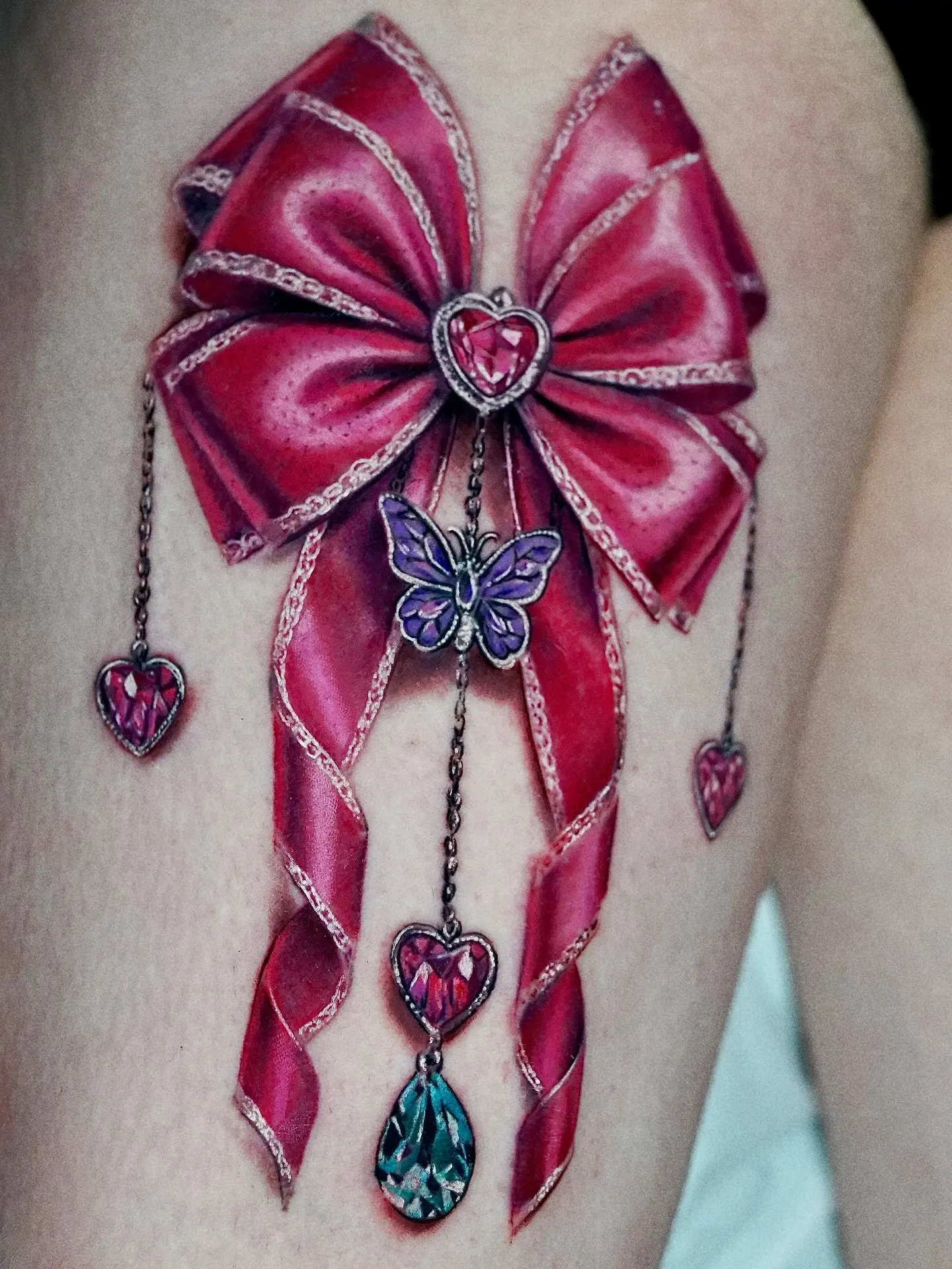 Elegant bow tattoo with vibrant embellishments