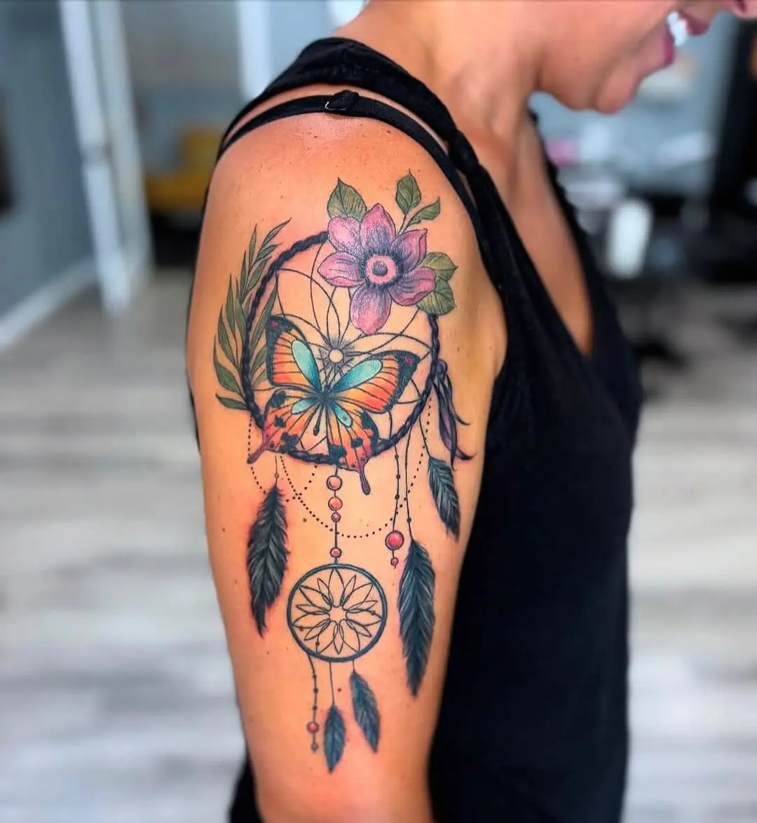 Vibrant dreamcatcher tattoo with butterfly and flowers