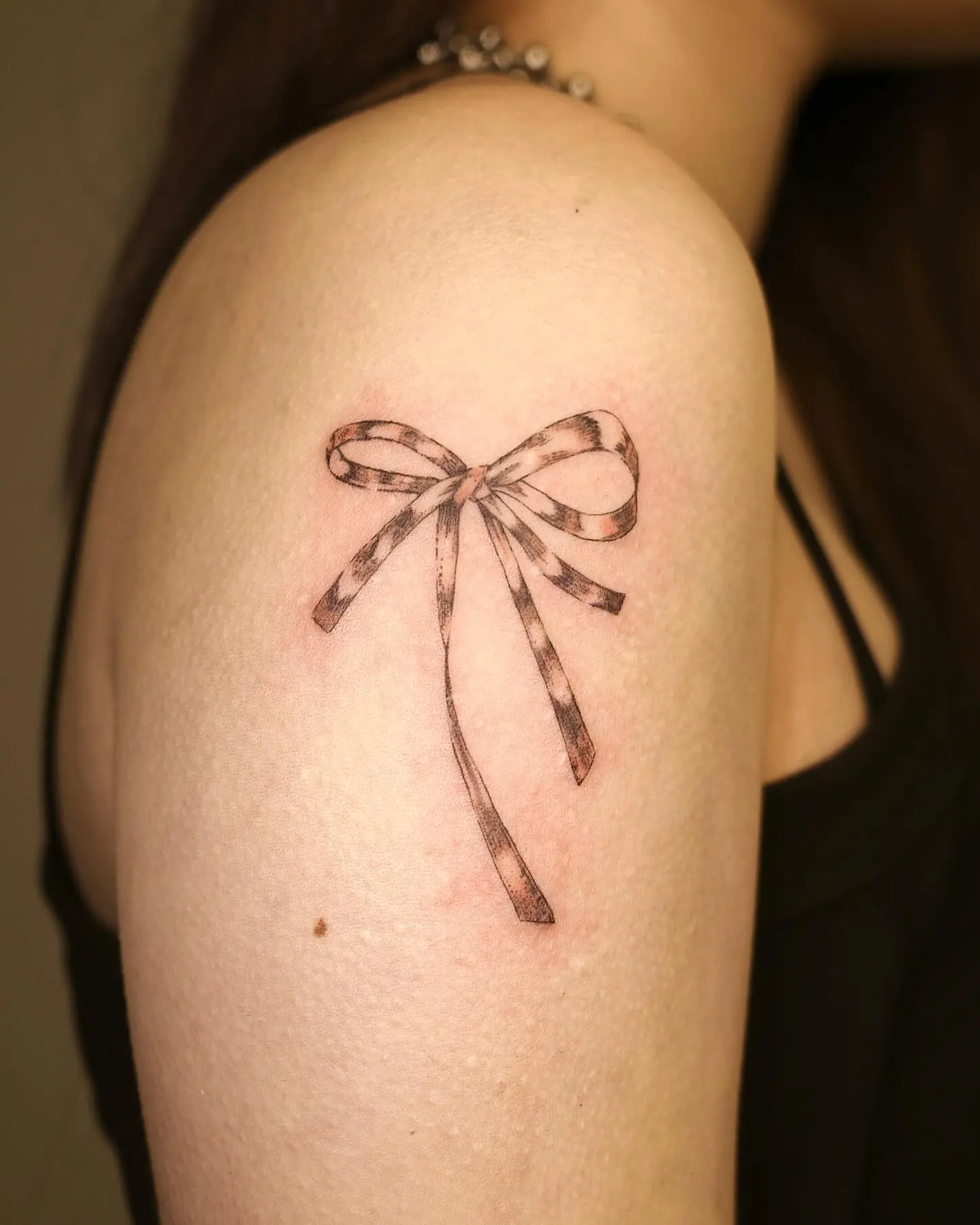 Elegantly Crafted Bow Tattoo on Inner Arm
