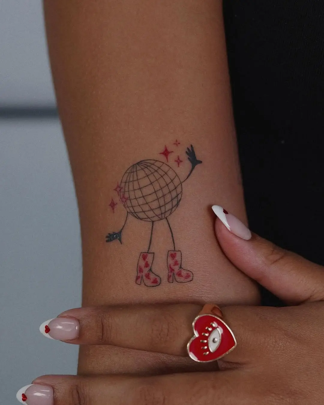 Chic disco ball tattoo with stylish boots