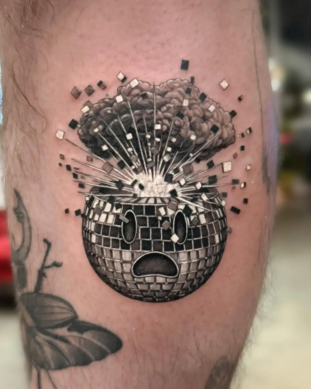 Unique explosion-themed disco ball tattoo design