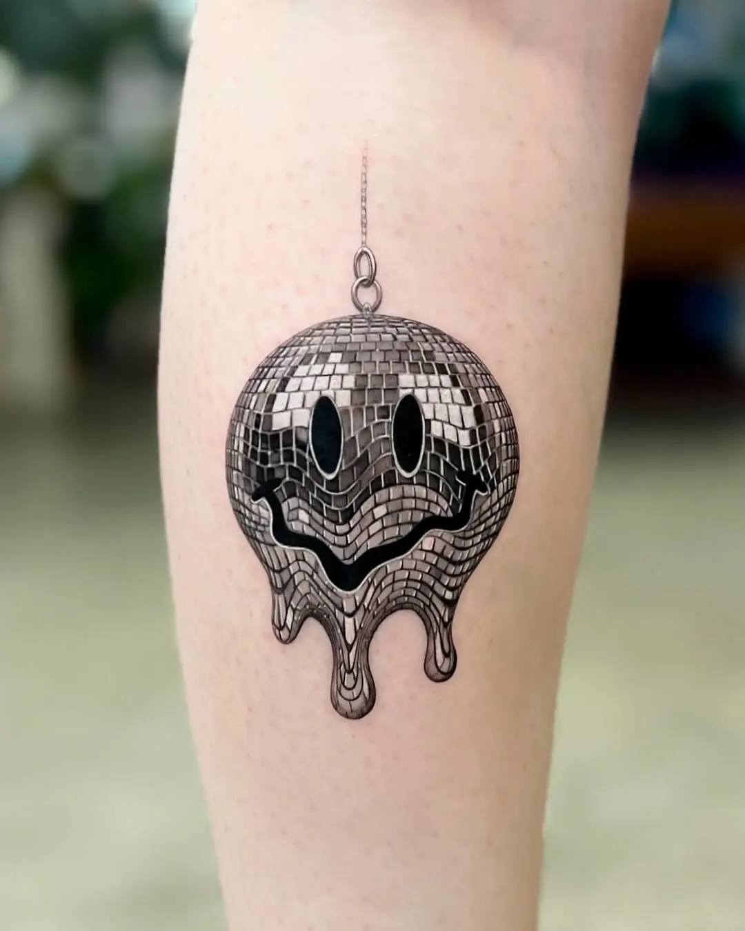 Playful disco ball tattoo with a happy vibe