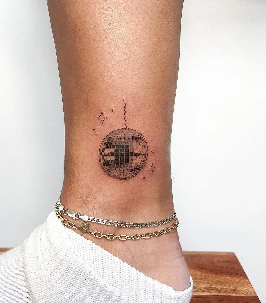 Charming minimalist disco ball ankle tattoo design