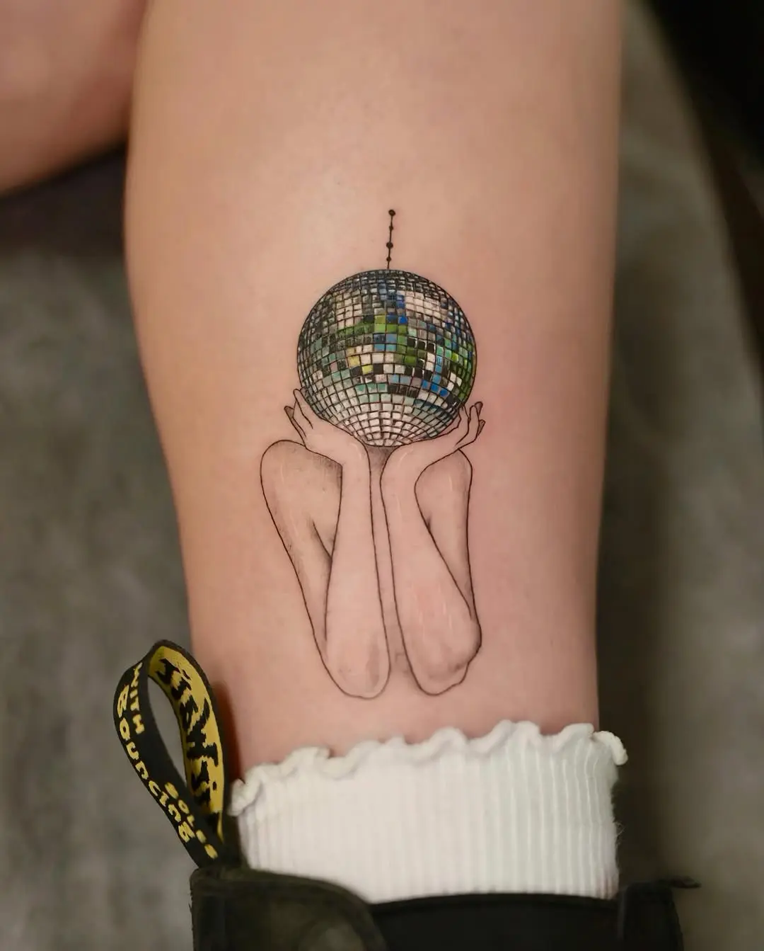 Enchanting disco ball tattoo with elegant design