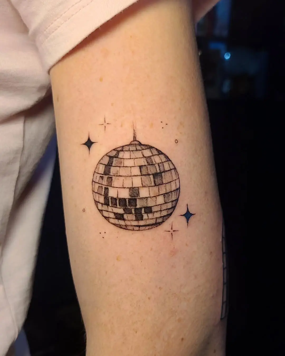 Stylish disco ball tattoo on the arm