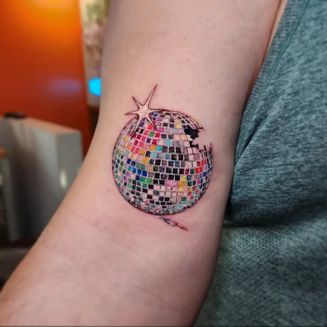 Colorful disco ball tattoo on the arm