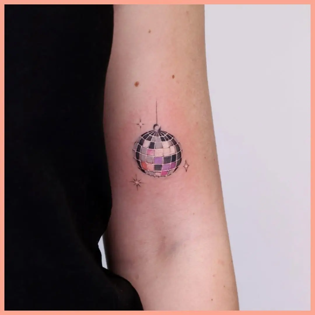 Colorful disco ball tattoo with sparkling accents