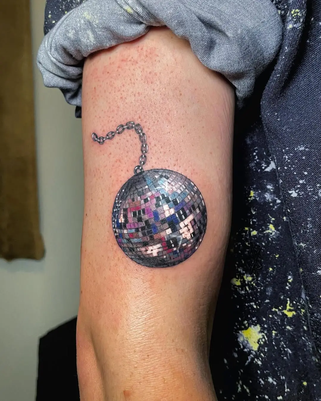 Vibrant disco ball tattoo with stunning details