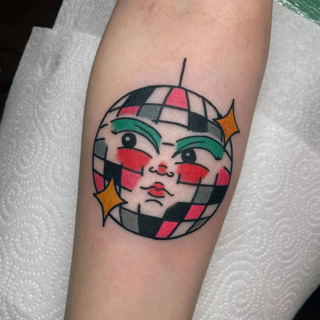 Stylish disco ball tattoo with unique face design