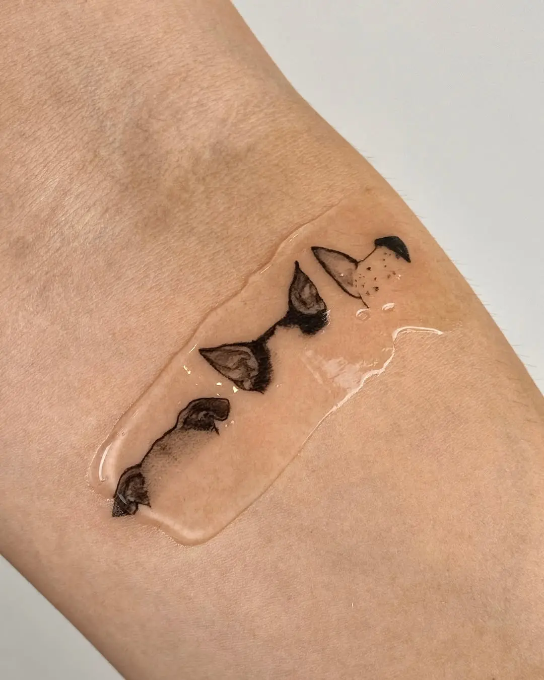 Charming minimalist dog ear tattoo design