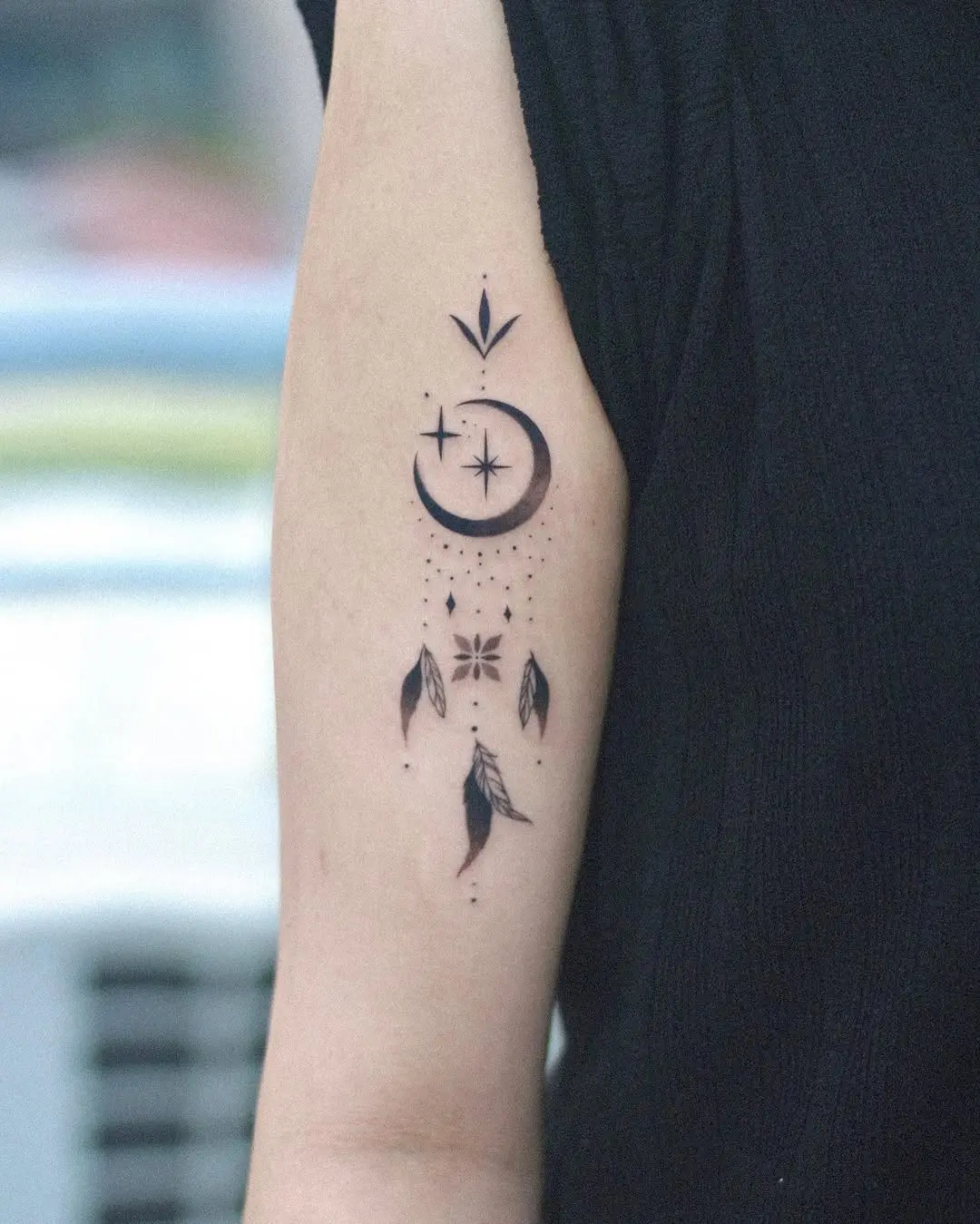 Elegant black and white dreamcatcher tattoo design