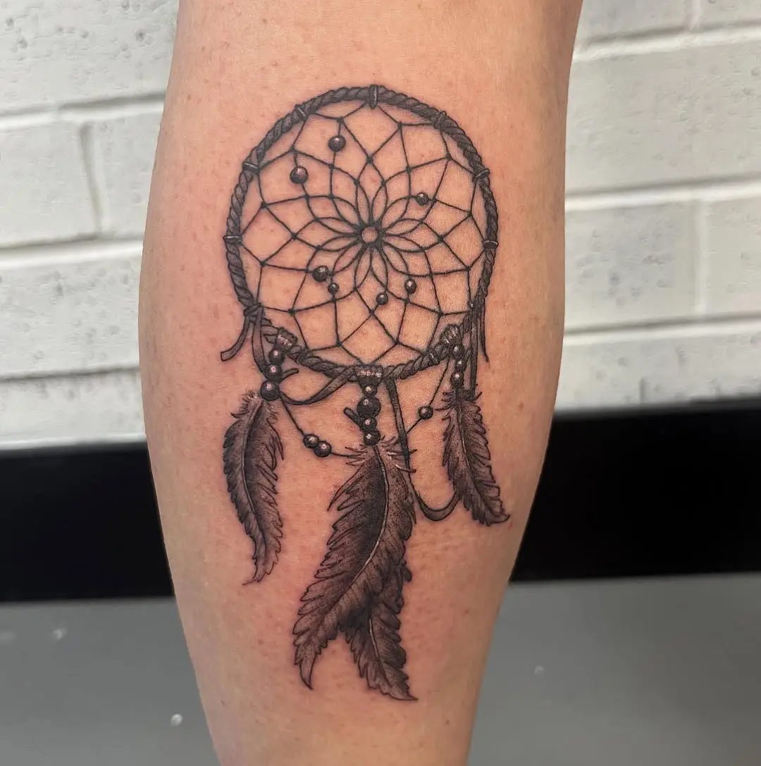Intricate black ink dreamcatcher tattoo design