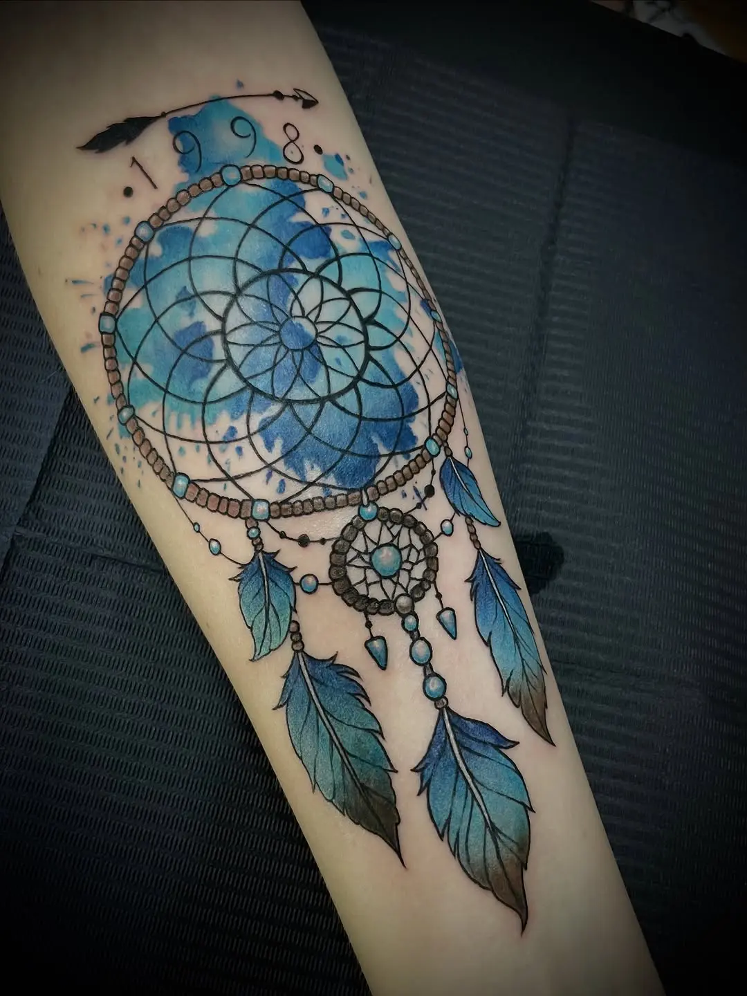 Dynamic Blue Dreamcatcher Tattoo with Feathers
