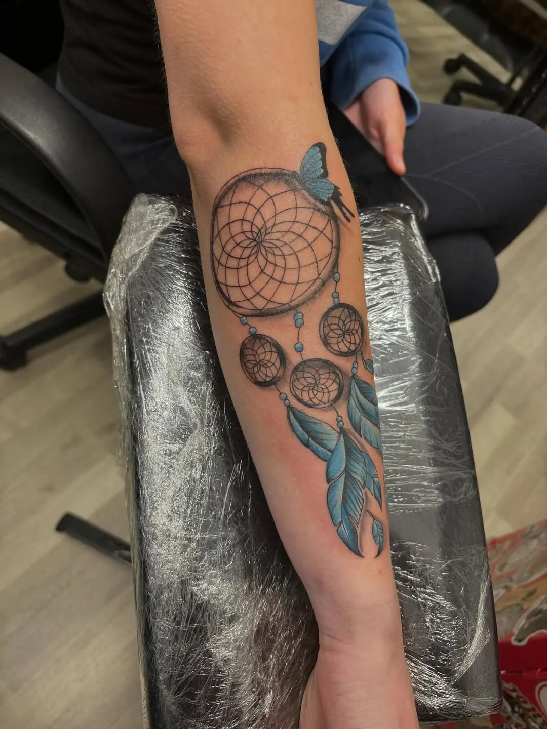 Vibrant dreamcatcher tattoo with feathers