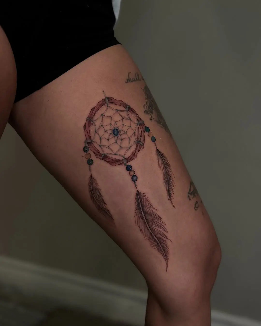 Stylish dreamcatcher tattoo on the thigh