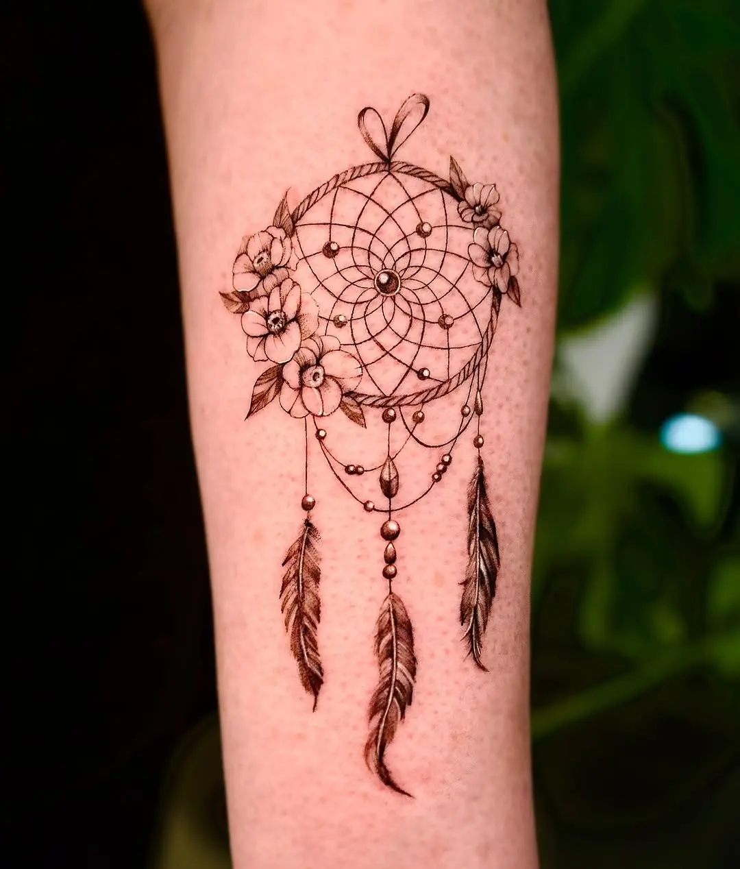 Elegant floral dreamcatcher tattoo design