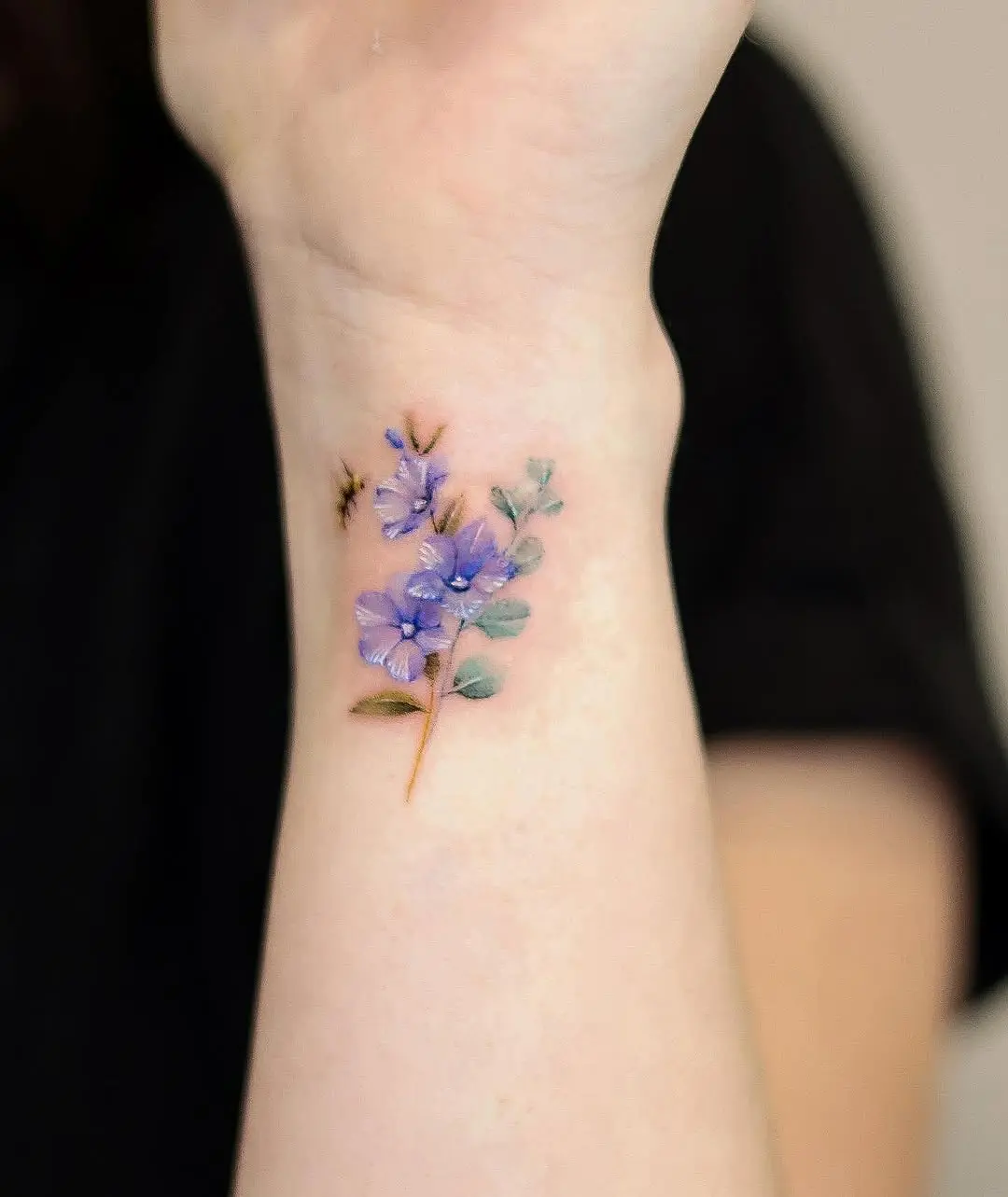 Delicate eucalyptus flower tattoo on the wrist