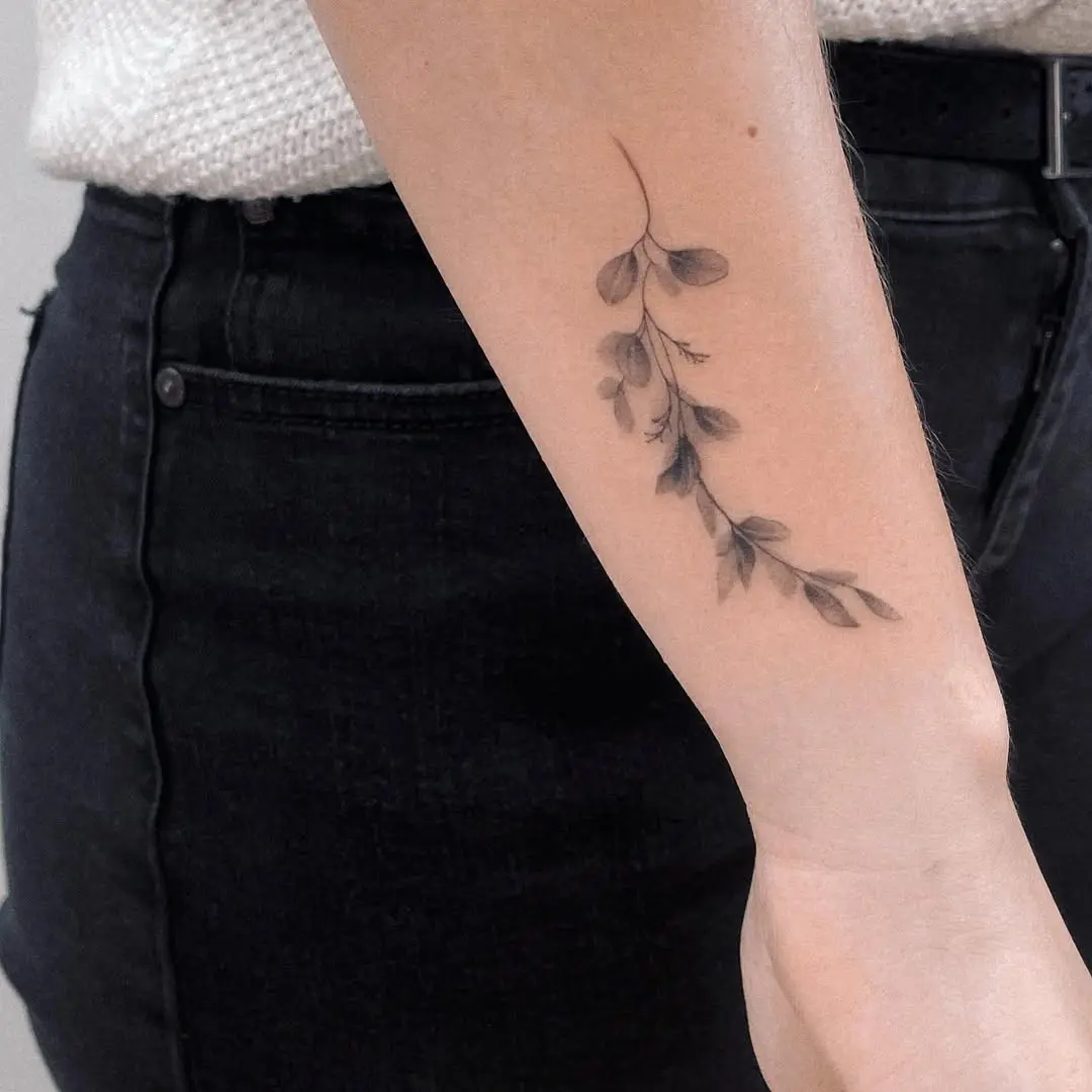 Elegant eucalyptus tattoo on the forearm