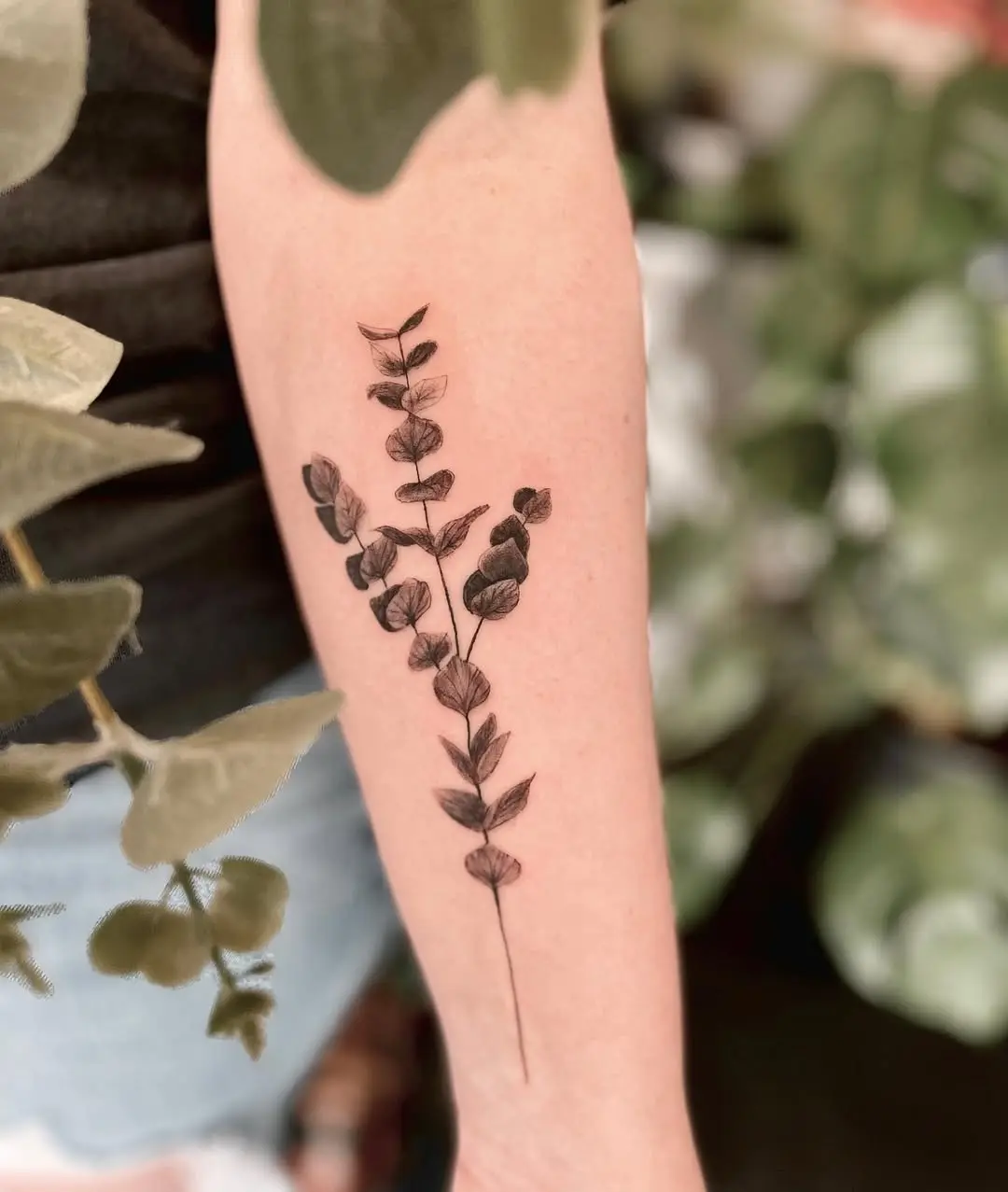 Elegant eucalyptus tattoo on the forearm