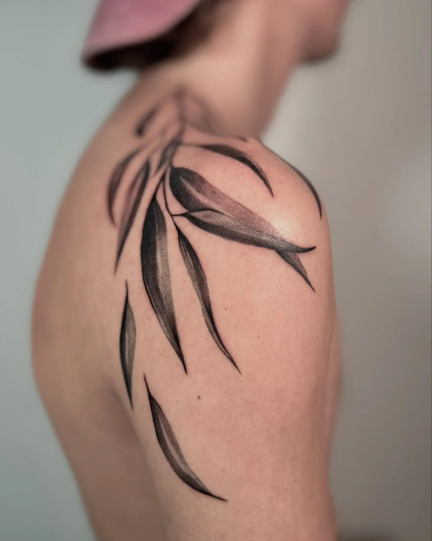 Artistic eucalyptus design on shoulder