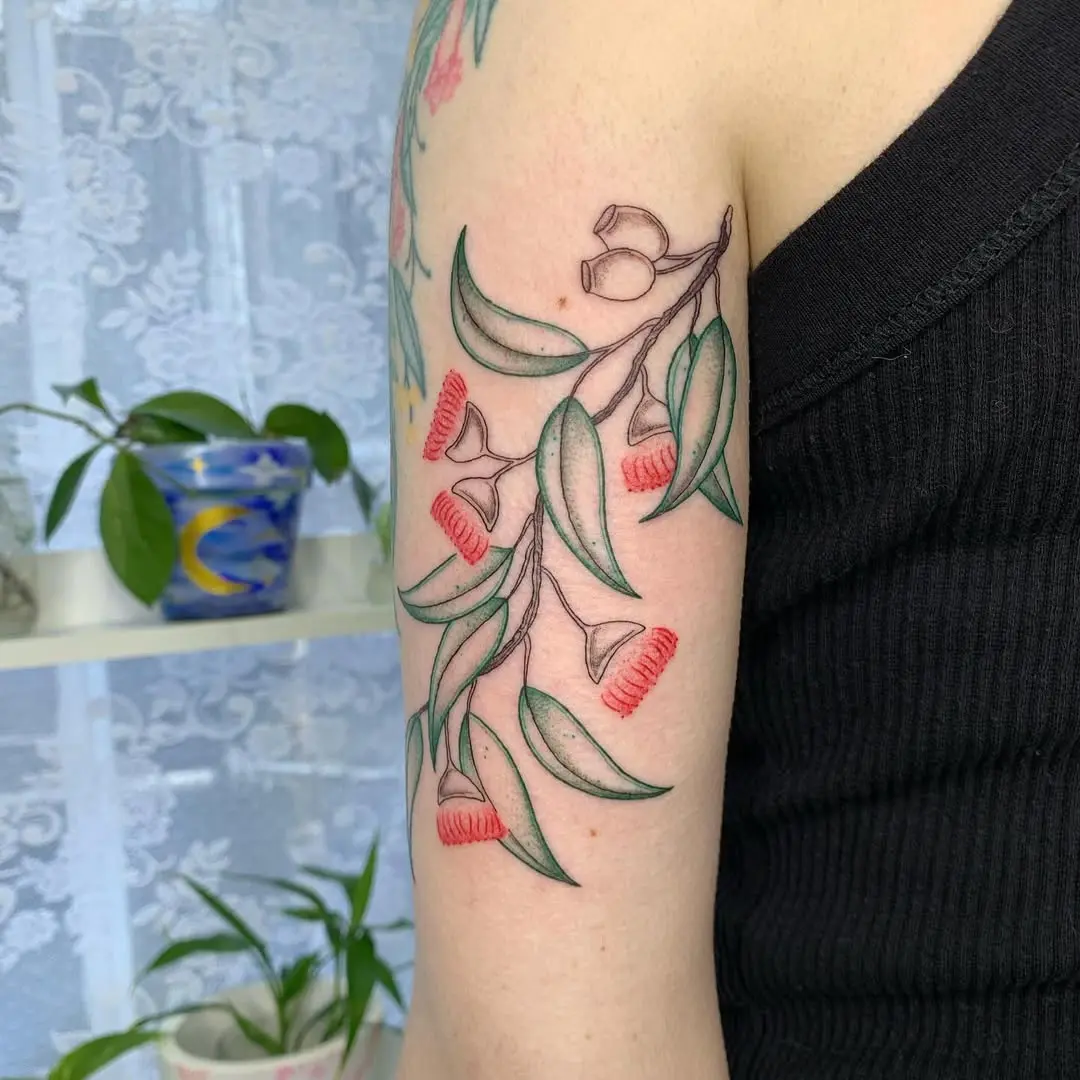 Stunning eucalyptus tattoo with vibrant blossoms