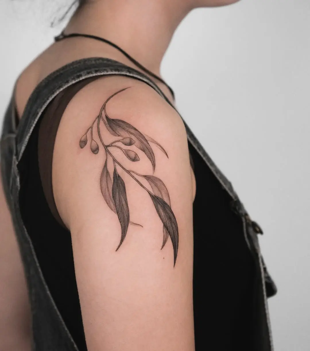 Elegant eucalyptus tattoo with intricate line work