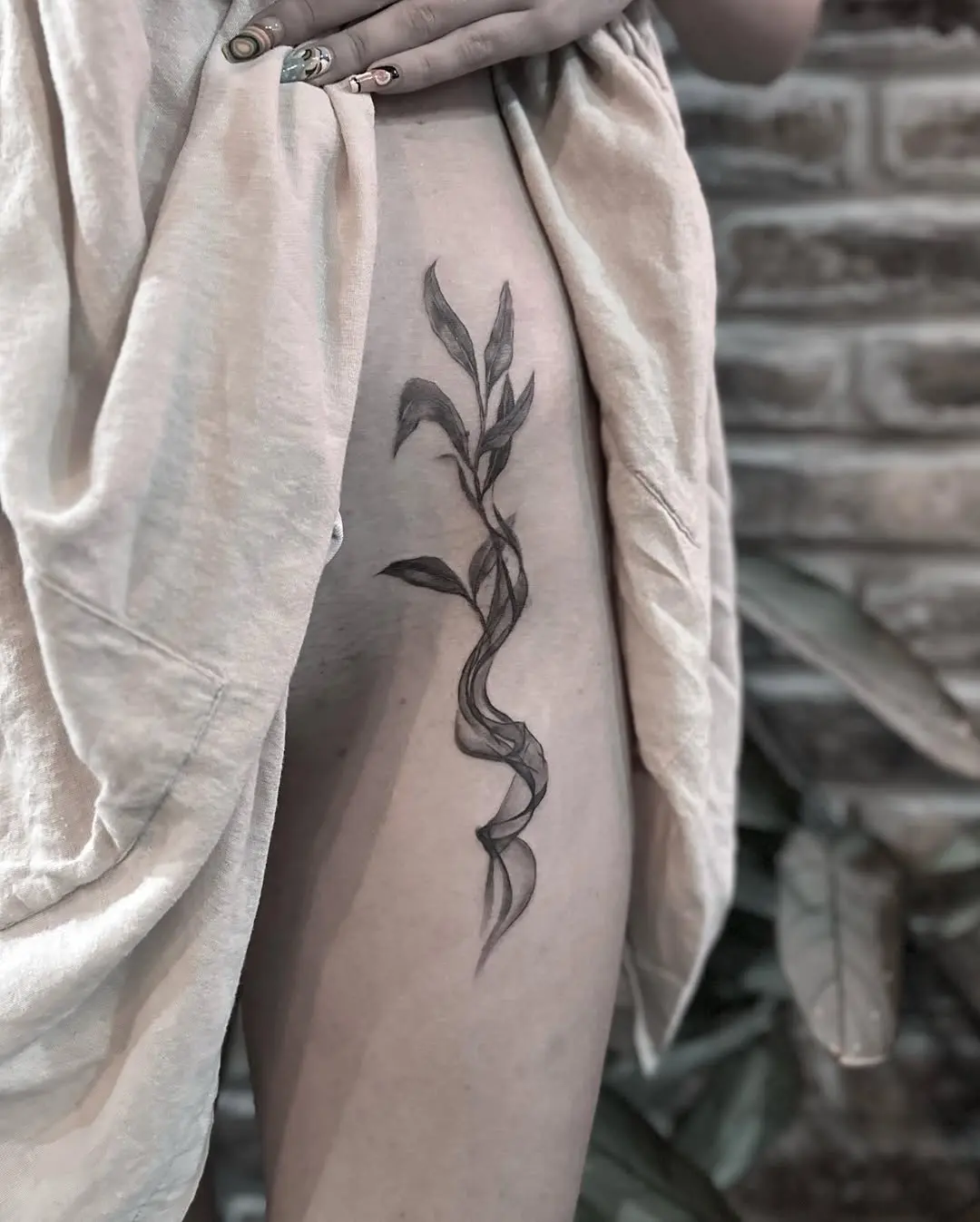 Elegant eucalyptus tattoo with flowing design