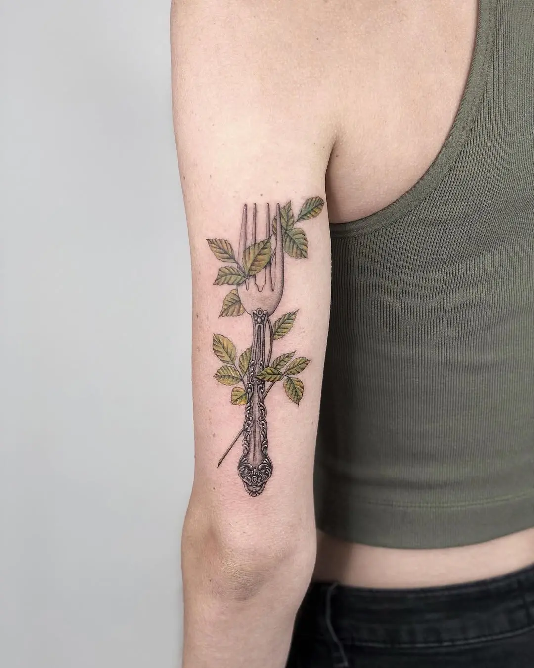 Artistic Fork Tattoo Design with Green Leaves
