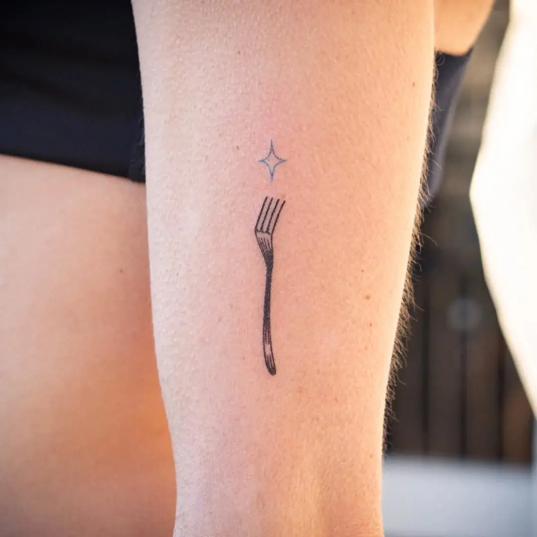 Minimalistic Fork Tattoo with a Star Accent