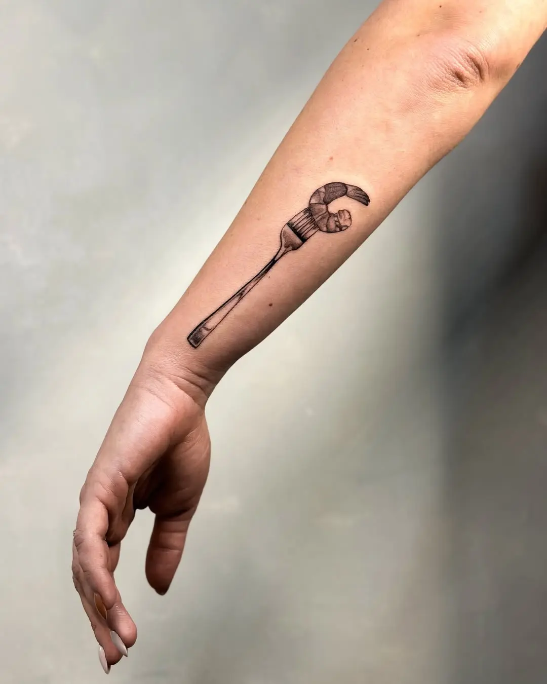 Stylish and playful fork tattoo design