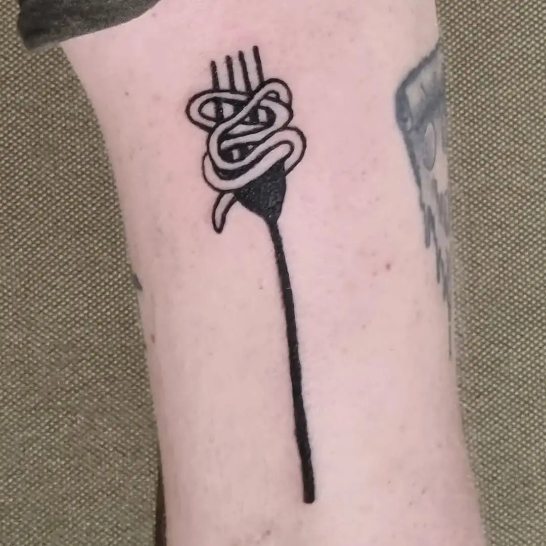 Unique fork tattoo entwined with artistic flair