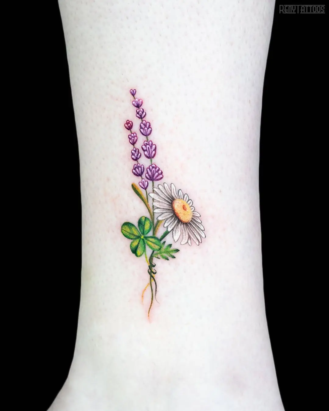 Charming four leaf clover and flower tattoo.