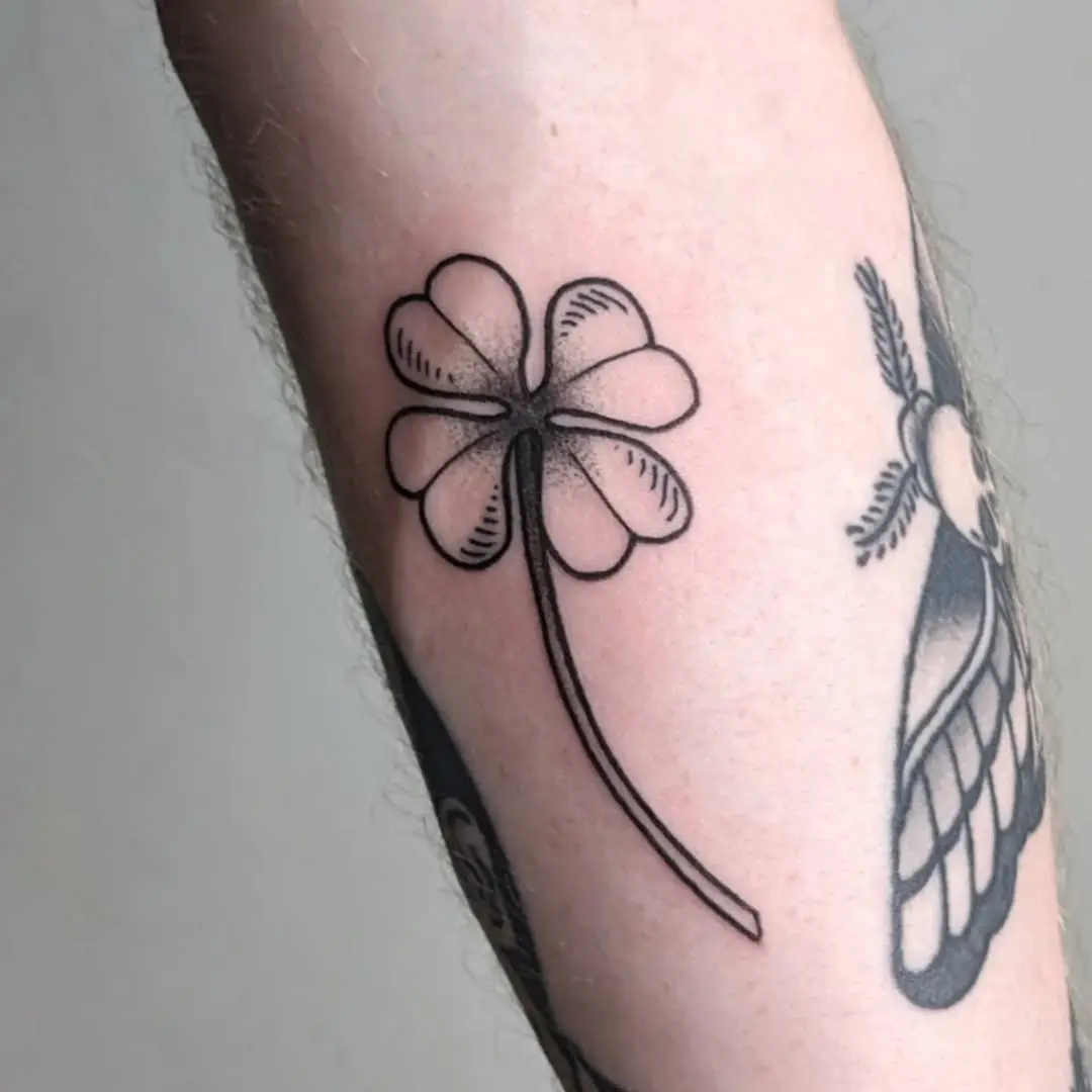 Minimalist four-leaf clover tattoo design