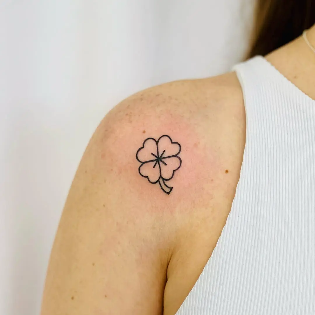 Charming minimalist four-leaf clover tattoo