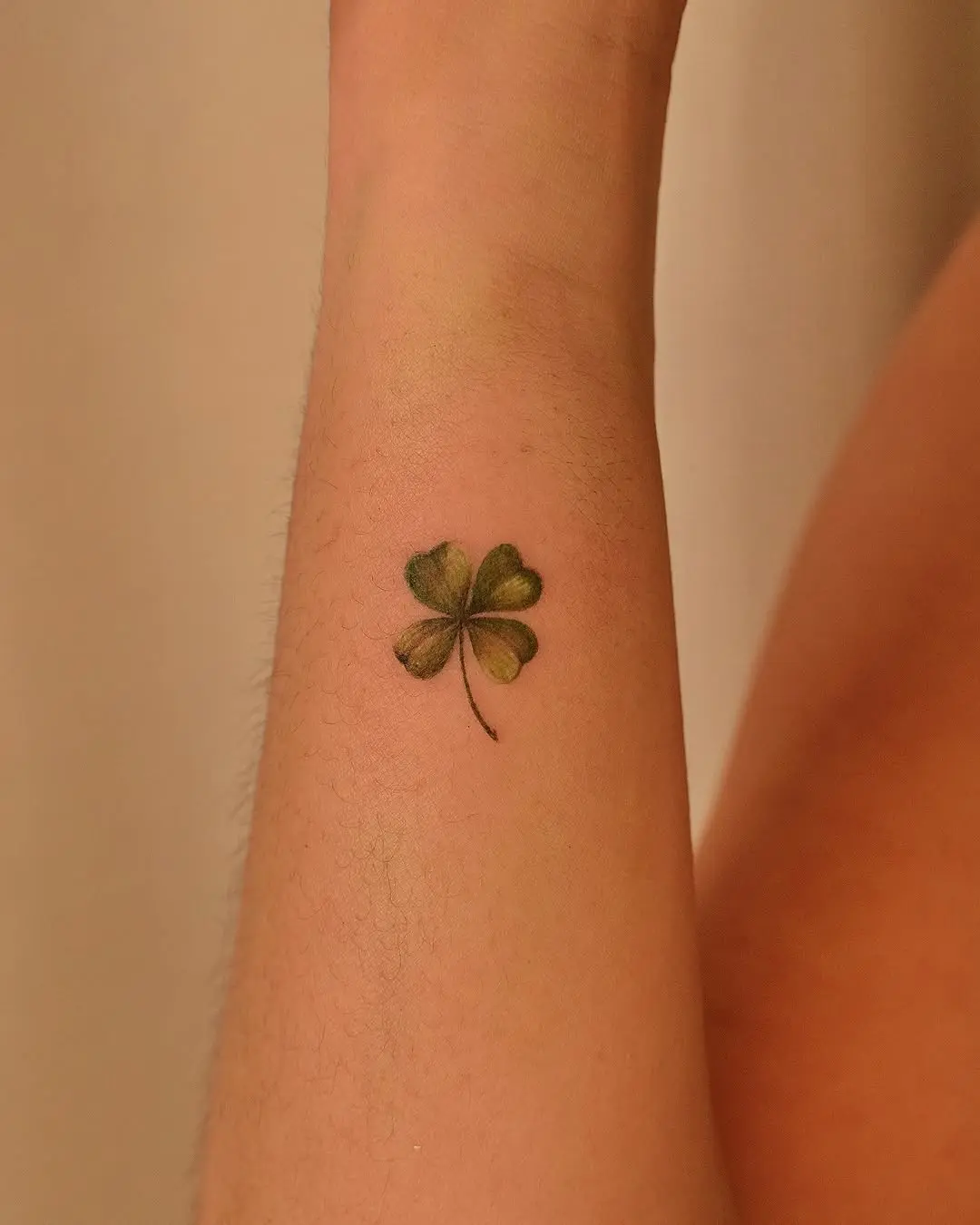 Elegant four leaf clover tattoo on the arm